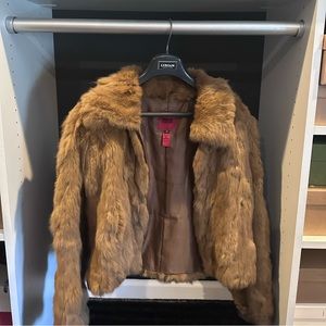 This rabbit fur jacket is brown, and a size medium. The brand is bomb boogie.